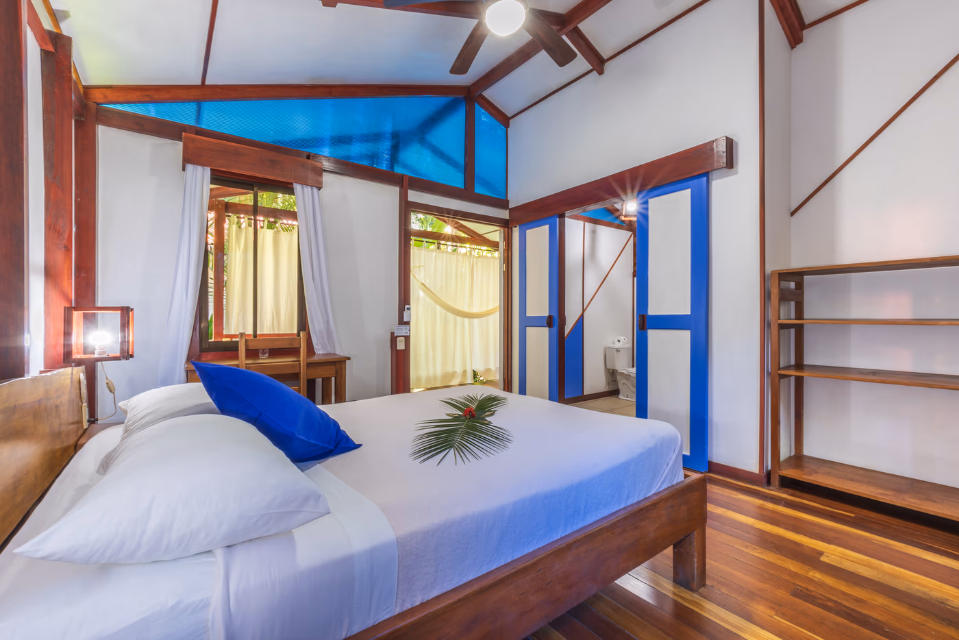 Deluxe Bungalow queen bedroom with tropical hardwood and natural light