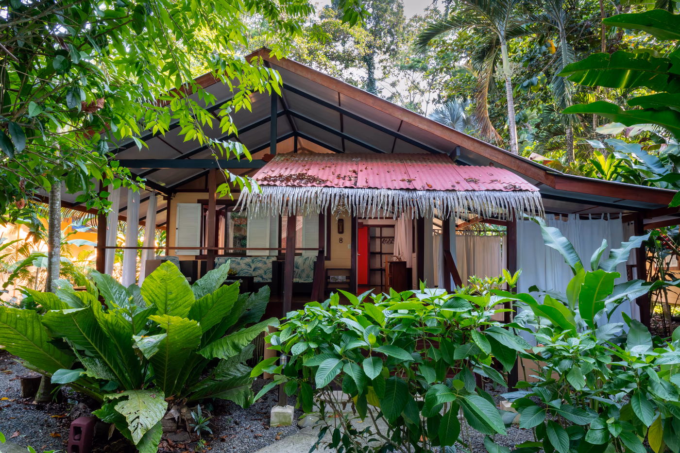 Suite Bungalow exterior with private terrace and jacuzzi, surrounded by tropical garden