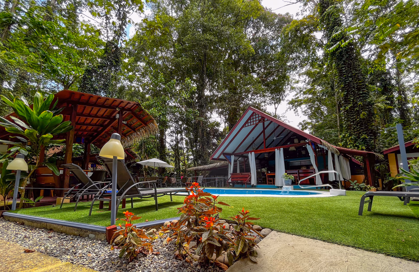 Tropical garden pool surrounded by lush vegetation at Namuwoki Lodge, Costa Rica